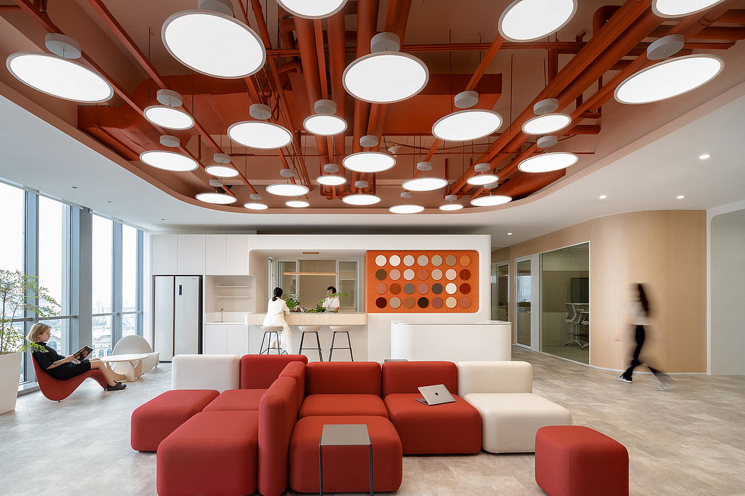 Cozy office with vibrant red sofas, creative lighting fixtures, and minimalist design.