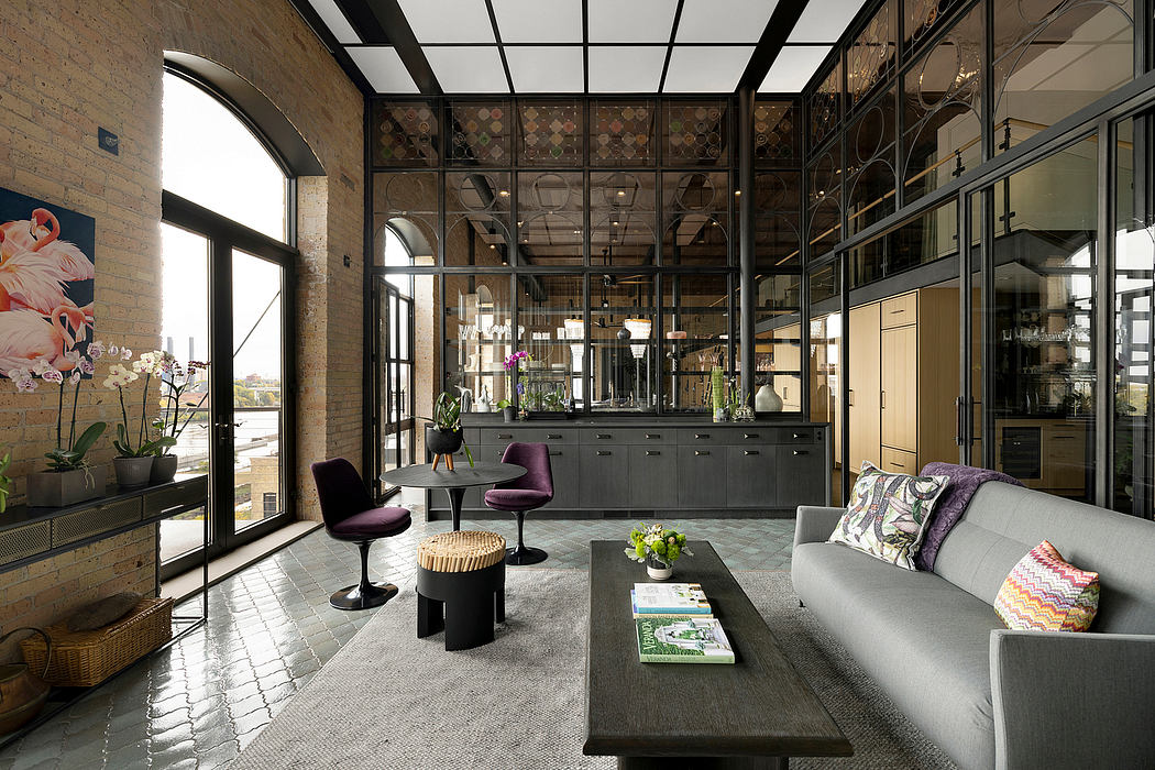 A modern and stylish industrial-inspired living space with glass walls, minimalist furnishings, and botanical accents.