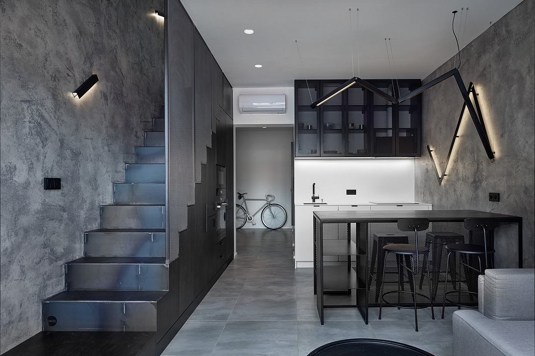 Minimalist apartment interior with steel staircase, industrial-style kitchen, and muted tones.