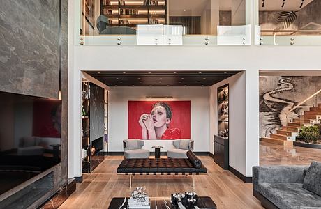 Sleek, modern living space with vibrant artwork, built-in shelving, and minimalist furniture.