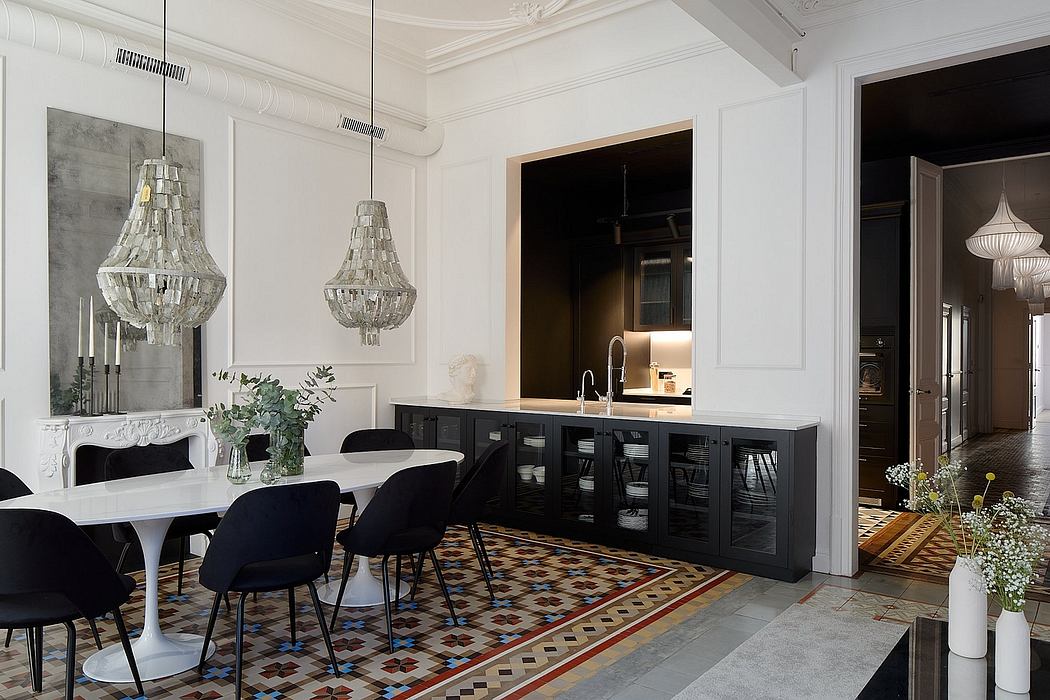 Elegant dining room with ornate chandeliers, patterned tile floor, and sleek black cabinetry.