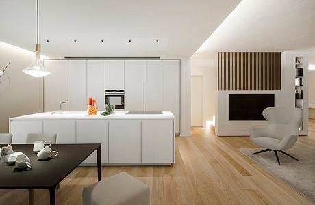 Sleek modern kitchen with white cabinetry, wood floors, and minimalist decor.