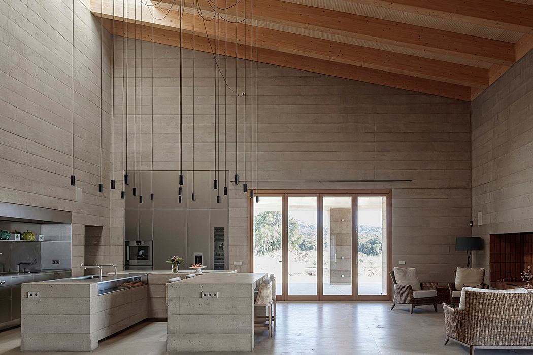 Open, modern kitchen with concrete countertops, wood-beamed ceiling, and large windows.