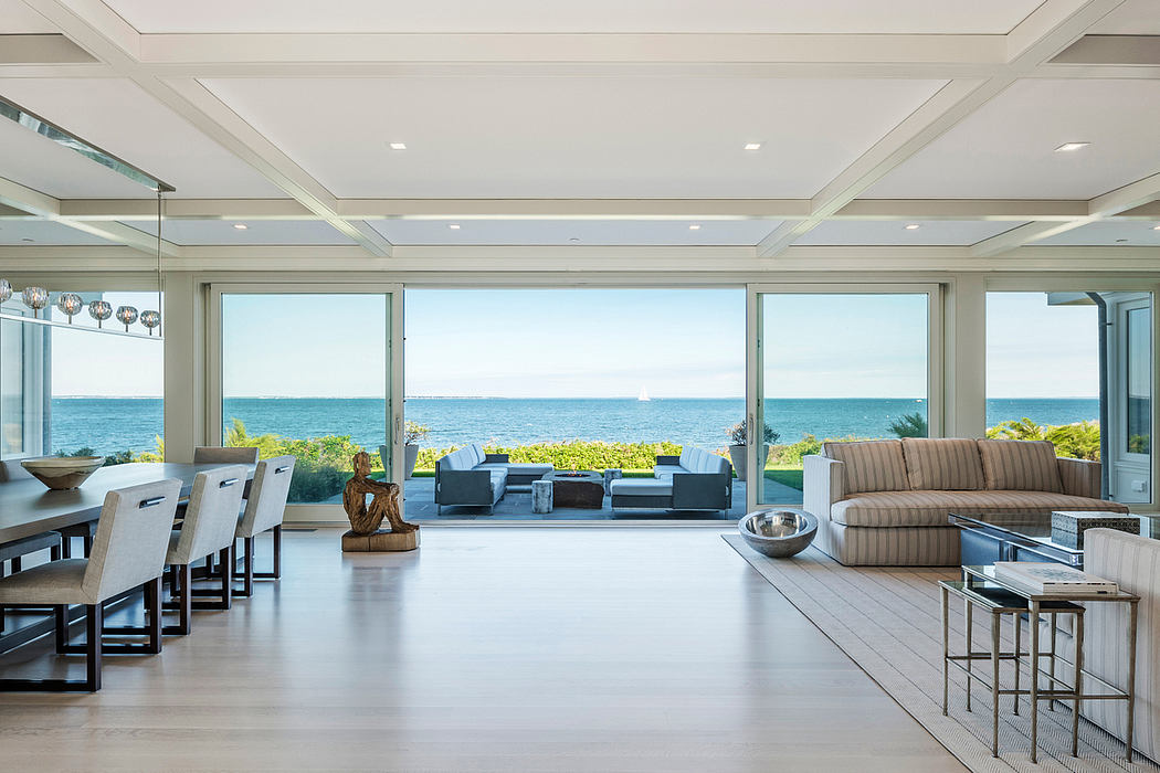 Spacious open-concept living area with panoramic ocean views, contemporary furnishings.