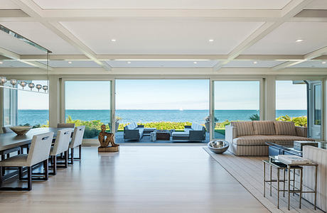 Spacious open-concept living area with panoramic ocean views, contemporary furnishings.