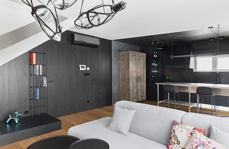 Sleek modern interior with minimalist decor, dark color scheme, and recessed lighting.