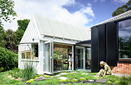 A modern, open-concept home surrounded by lush greenery and featuring clean architectural lines.