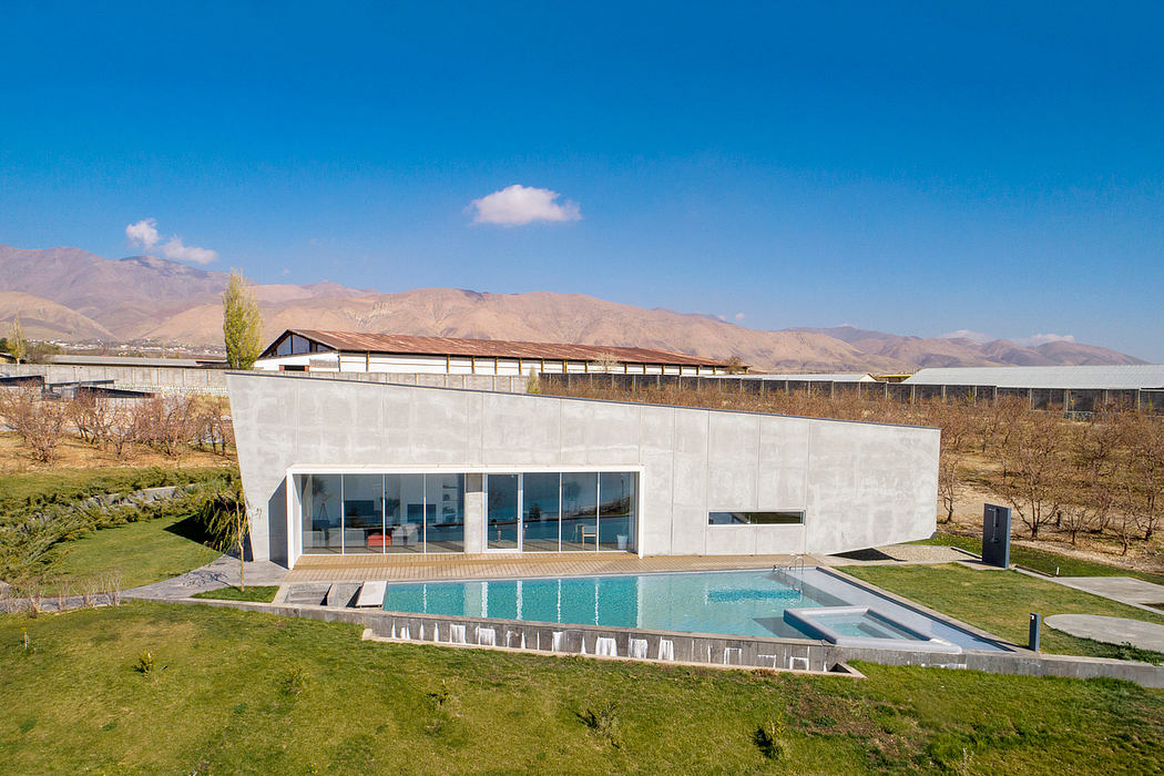 Sleek, modern architecture with a serene outdoor pool and mountainous backdrop.