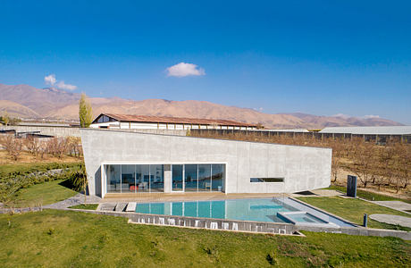 Sleek, modern architecture with a serene outdoor pool and mountainous backdrop.