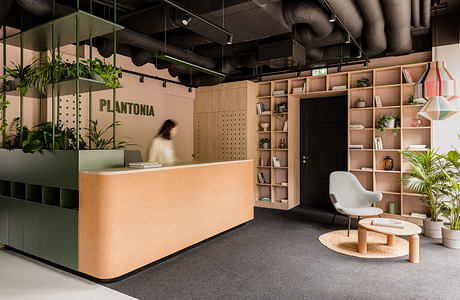 A modern office reception with sleek wood furniture, plant displays, and a minimalist design.