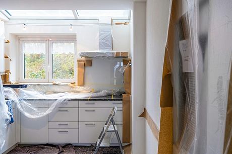 Newly renovated kitchen with modern cabinetry, skylights, and protected flooring.