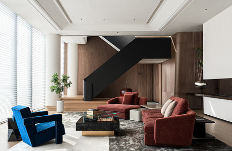 A modern, minimalist living space with bold geometric patterns, luxurious textiles, and sleek furnishings.