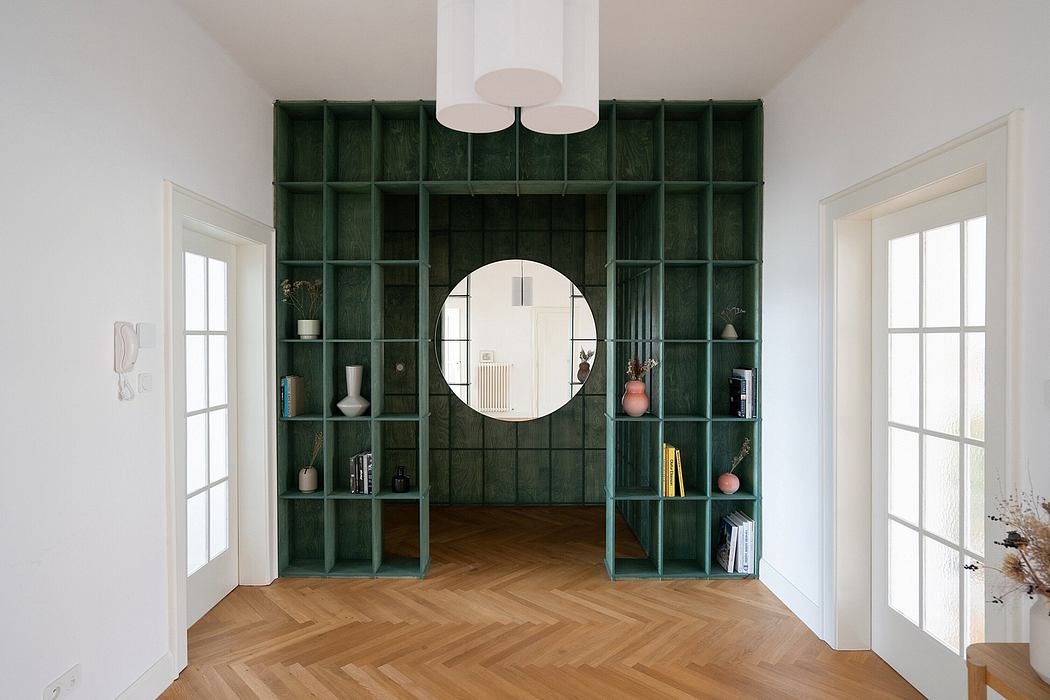 Minimalist room with green metal shelving unit and round mirror, parquet flooring.