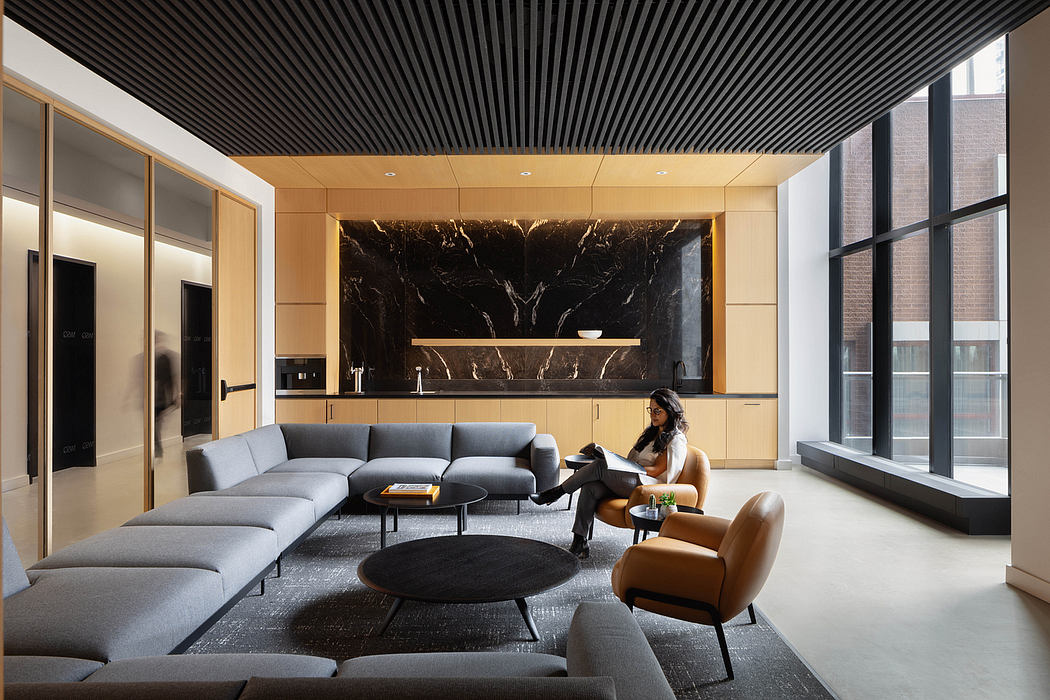 Sleek, modern living room with black marble feature wall, wood-paneled ceiling.