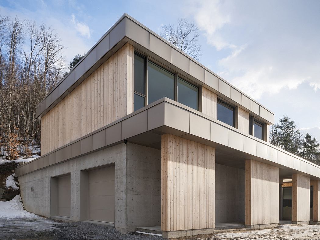A modern, minimalist residential structure with a mix of concrete, wood, and glass.