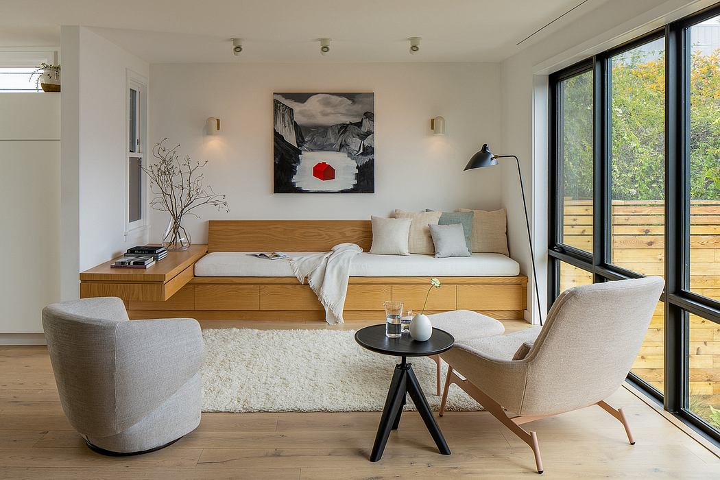 Cozy living space with wooden platform bed, plush seating, and nature-inspired artwork.