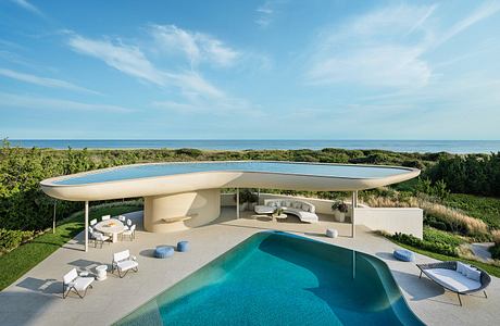 Modern luxury villa with infinity pool, covered patio, and panoramic ocean views.