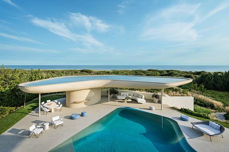 Modern luxury villa with infinity pool, covered patio, and panoramic ocean views.