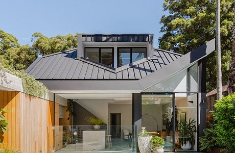 Modern home with sleek architectural design, open glass walls, and an inviting pool.