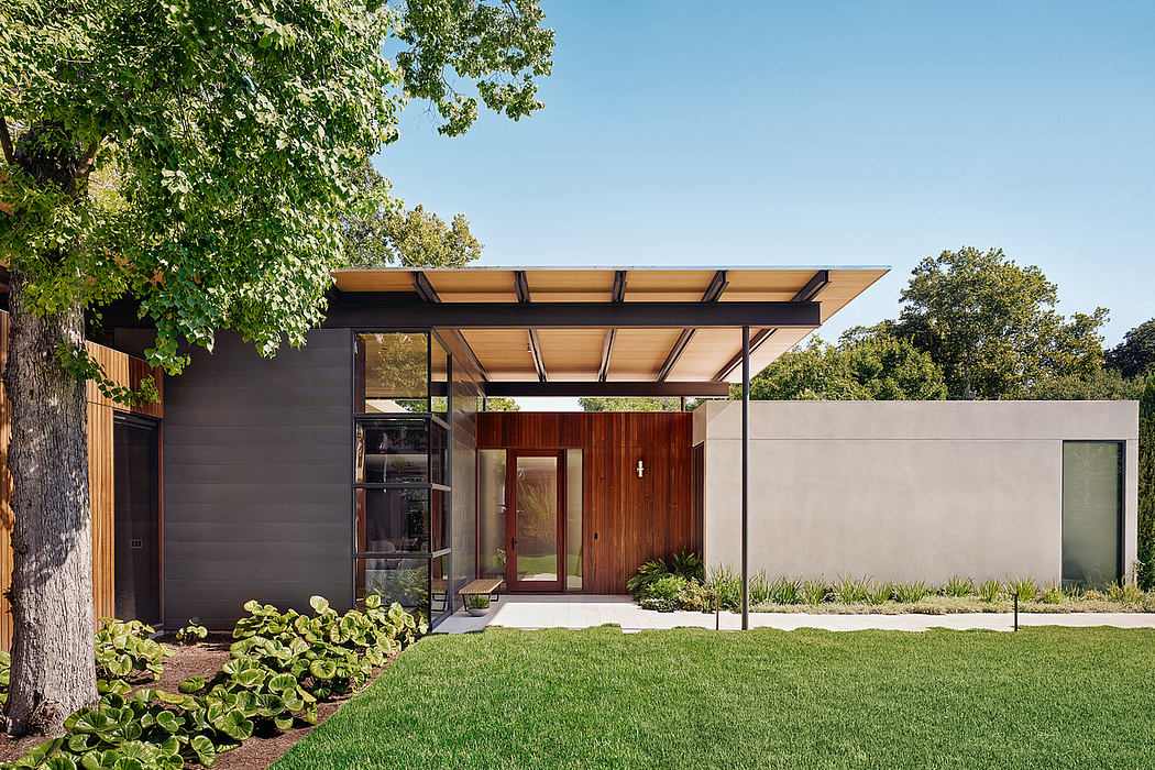 Modern single-story home with clean lines, warm wood accents, and a covered entry porch.