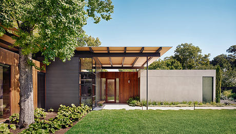 Modern single-story home with clean lines, warm wood accents, and a covered entry porch.