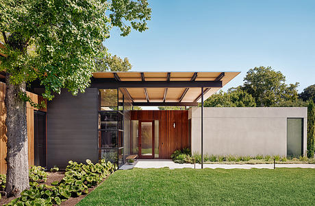 Modern single-story home with clean lines, warm wood accents, and a covered entry porch.