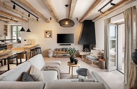 Cozy, rustic-style apartment with exposed wooden beams, modern furniture, and a fireplace.