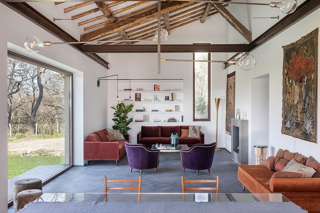 Rustic wooden beams, modern furniture, and vibrant artwork create a striking interior.