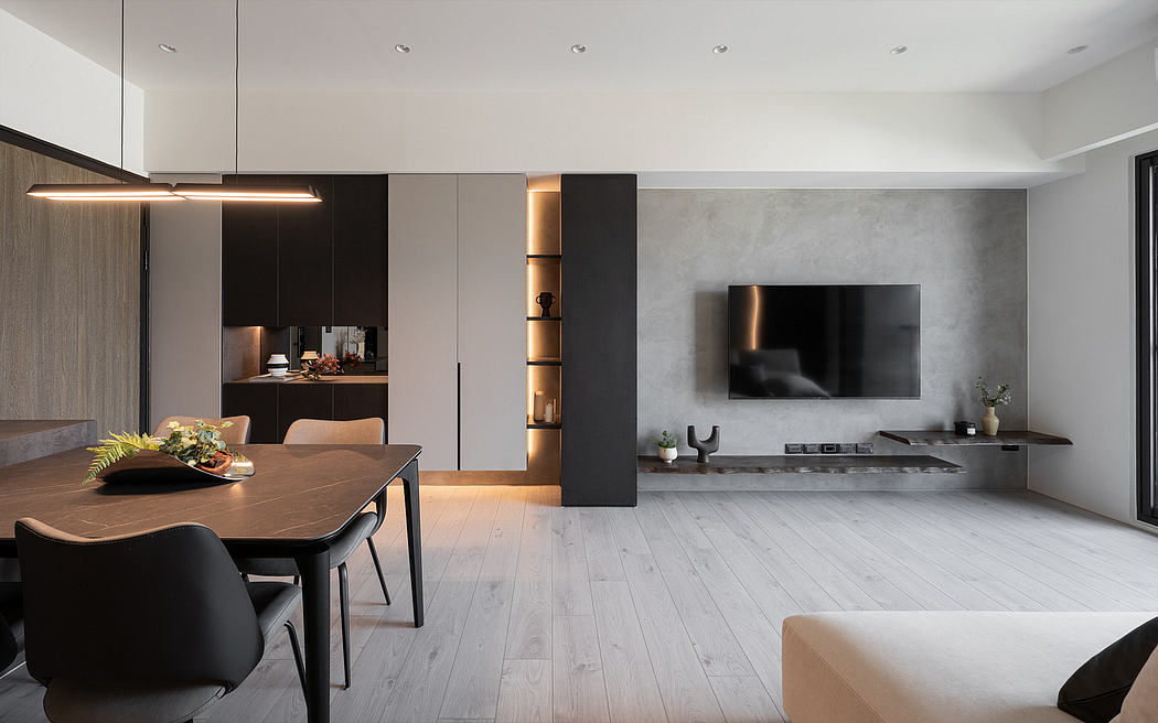 A modern, minimalist interior with warm lighting, wooden furniture, and a sleek TV setup.