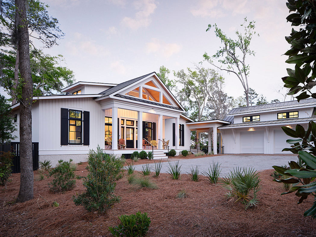 A modern farmhouse-style home with a covered porch, gabled roof, and large windows.