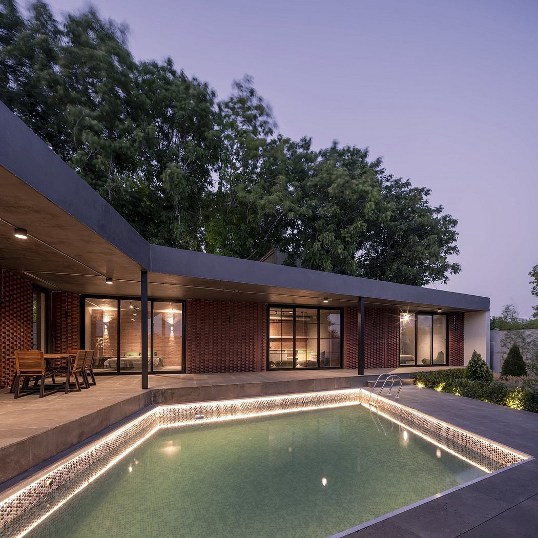 Sleek, modern brick home with expansive glass walls, pool, and landscaped outdoor space.