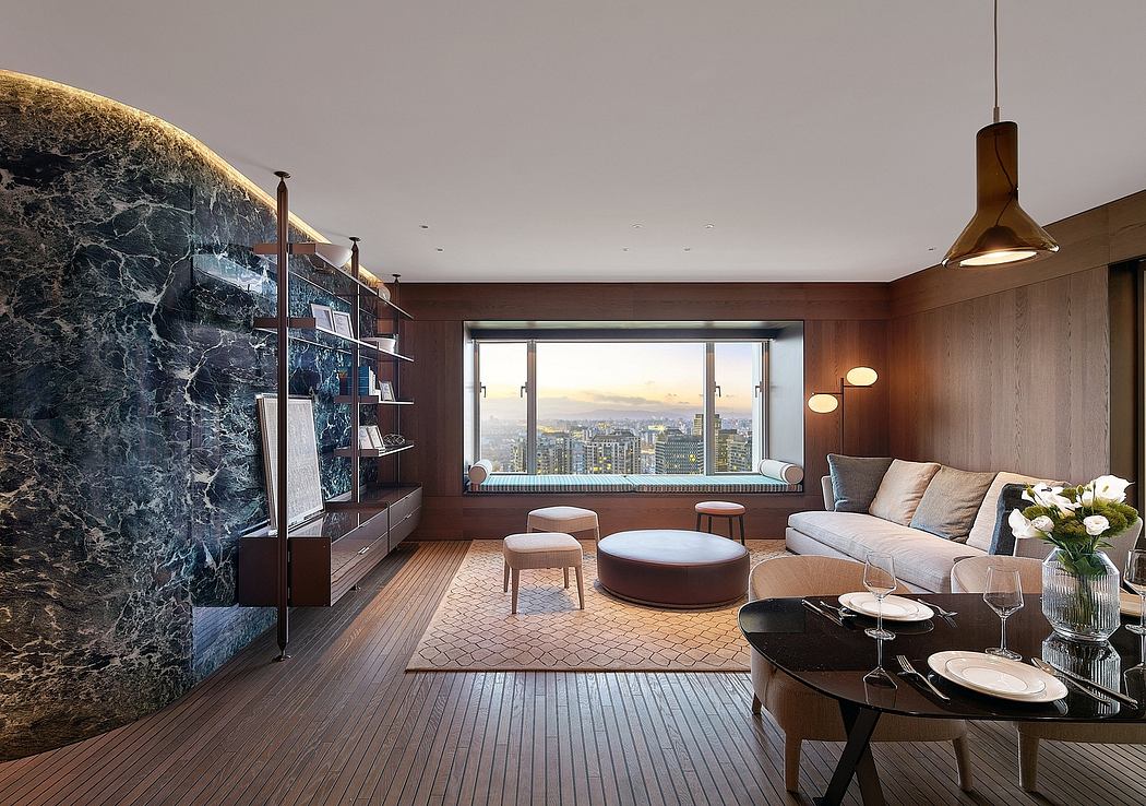 Luxurious modern living room with panoramic city view, sleek furnishings, and marble accent wall.