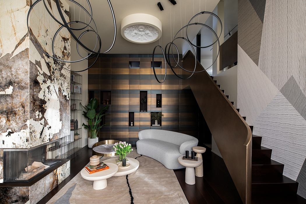 Striking modern interior with curved stairs, textured walls, and geometric light fixtures.