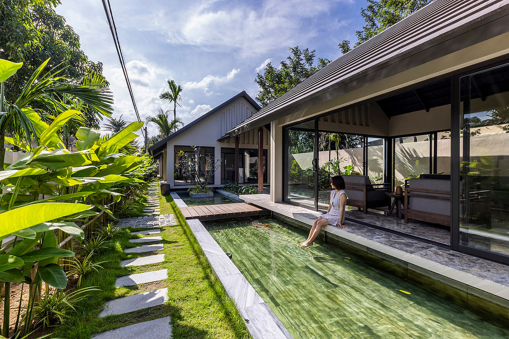 Lush tropical landscape surrounds modern, open-concept villa with inviting pool.