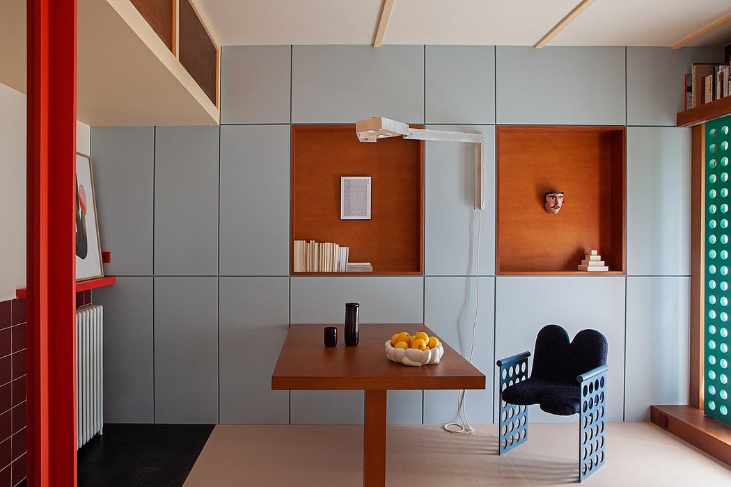 Minimalist modern interior with geometric wall panels, built-in shelving, and colorful accents.