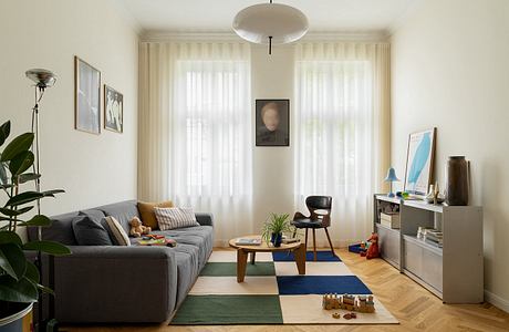 A cozy and well-designed living room with modern furniture, artwork, and natural lighting.