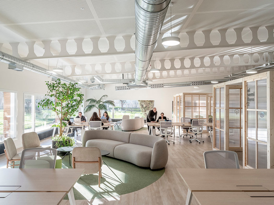 A modern, bright office space with open layout, natural lighting, and sleek furnishings.