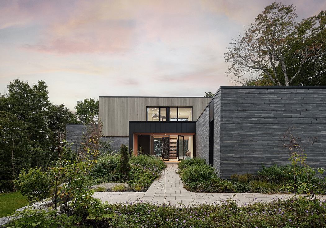 A modern, sleek house with clean lines, large windows, and a lush, well-designed garden.