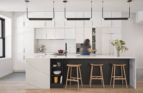 Modern kitchen with sleek white cabinets, black island, and wood bar stools. Minimalist lighting fixtures.