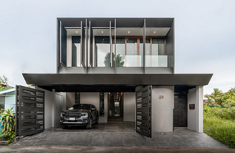 Modern, minimalist home with clean lines, large glass panels, and covered garage entrance.