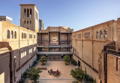 Impressive historical architecture with ornate towers, arches, and a central courtyard.