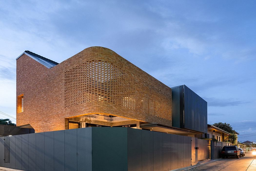 Striking brick architecture with intricate perforated facade, black exterior panels.