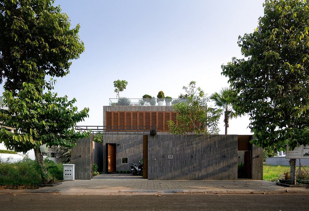 Modern residential building with concrete exterior, wooden screens, and rooftop garden.