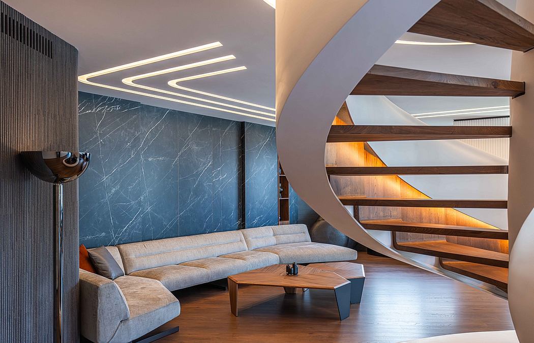 Sleek, modern living room with gray sofa, angular wooden staircase, and vibrant lighting.