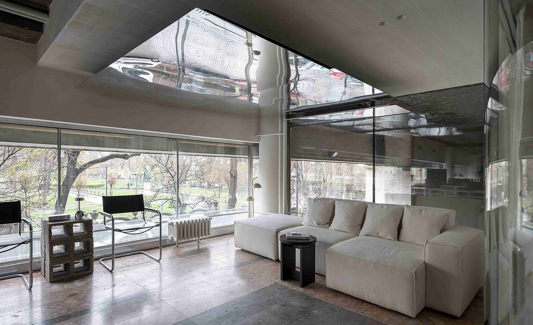 Spacious, modern living area with floor-to-ceiling windows, sleek furniture, and clean lines.