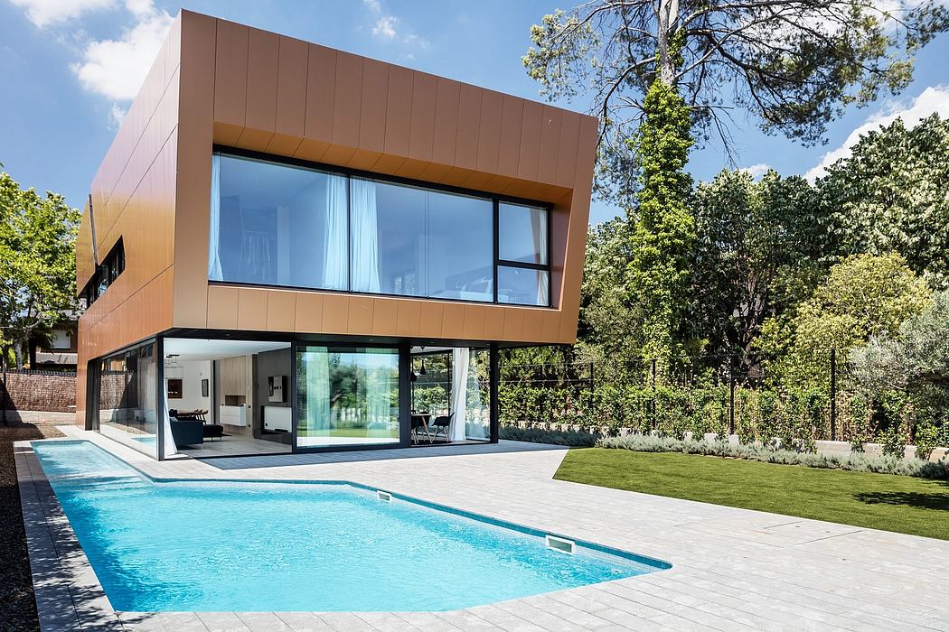 Modern architectural design featuring floor-to-ceiling glass, sleek copper panels, and a swimming pool surrounded by lush greenery.
