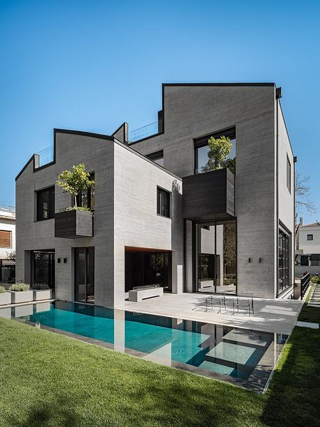 Sleek, modern architecture with bold geometric shapes, cantilevered balconies, and a stunning pool.