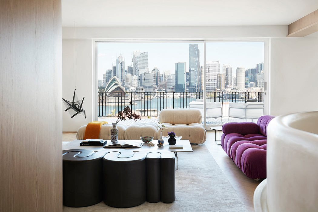 Sleek, modern living space with stunning city skyline view through large windows.