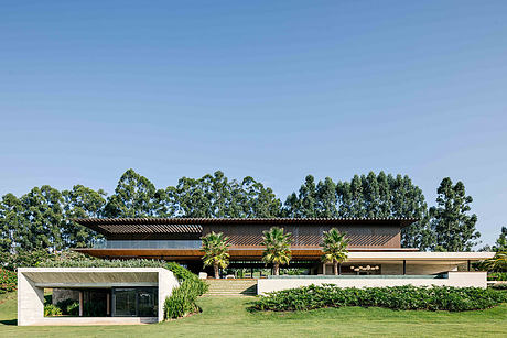 A modern, tropical-inspired architectural design with palm trees, glass walls, and a large overhanging roof.