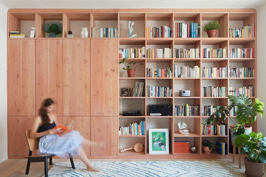 Expansive wooden shelving system with integrated storage compartments and seating area.